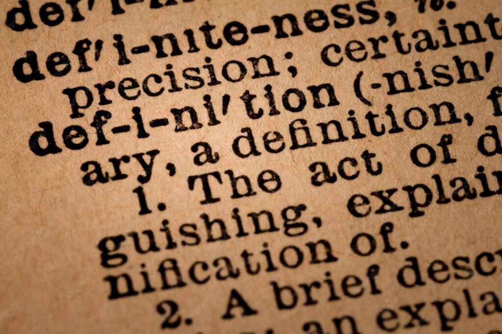 Premium Photo | Closeup of an opened dictionary showing the word definition